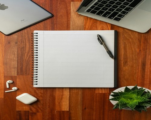 A notebook and a pen on a desk