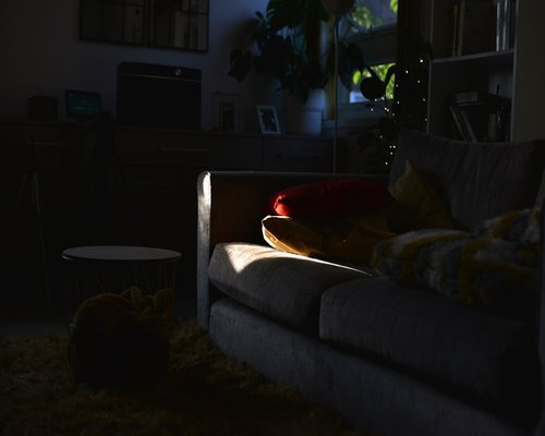 A laptop screen displaying text in a dimly lit room