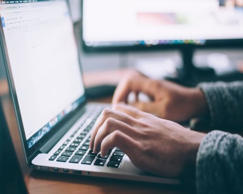 Person typing maintaining a healthy distance from the screen
